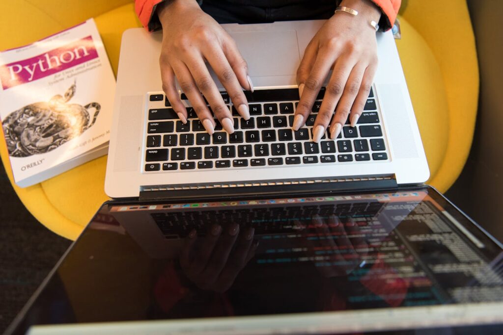 Woman Typing On Macbook Pro